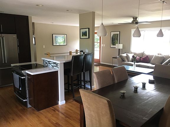 Open floor plan with living, dining, and kitchen