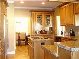 Gorgeous kitchen with granite, double ovens, island cook top, cabinets galore, under-cabinet lighting, breakfast bar, and serving bar!