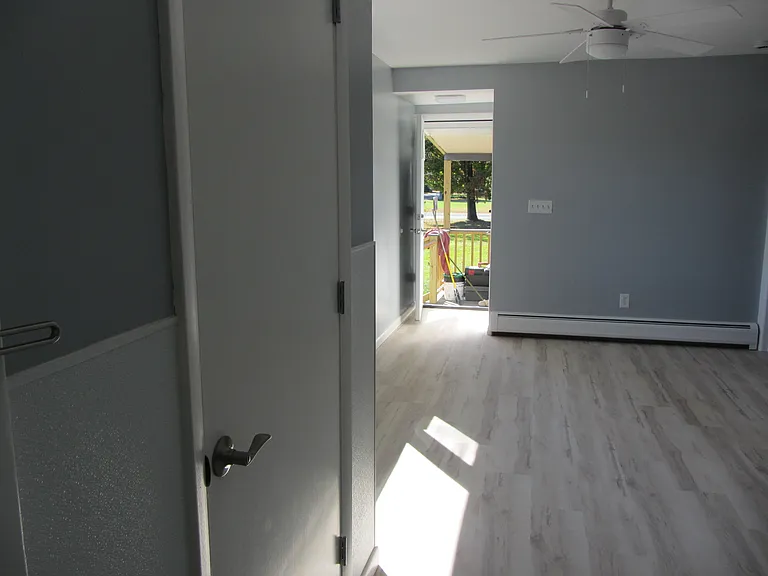 Front closet in living room looking out to the porch.