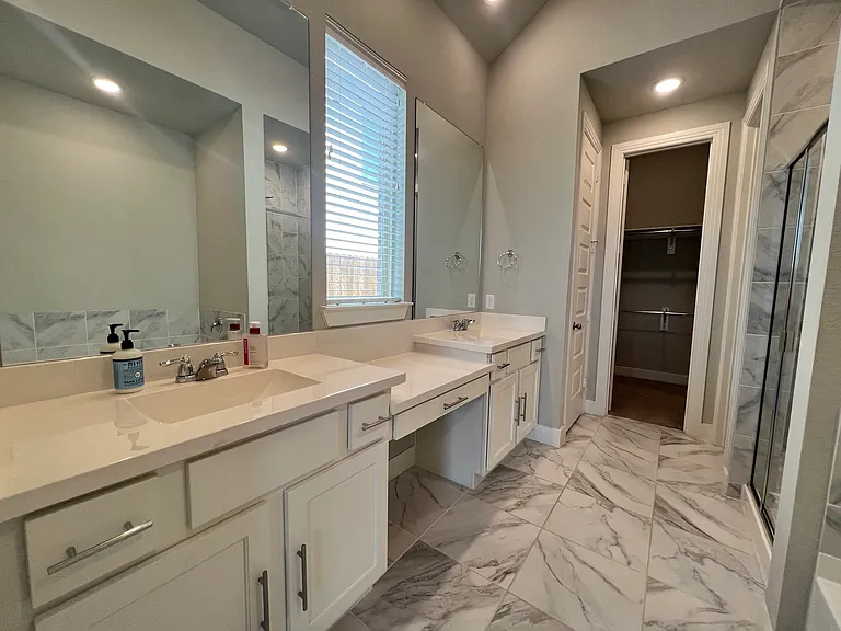 Primary bath with both large shower and soaking tub. Large walk-in closet.