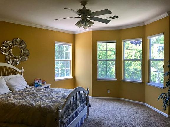 Master bedroom with windows opening to private yard