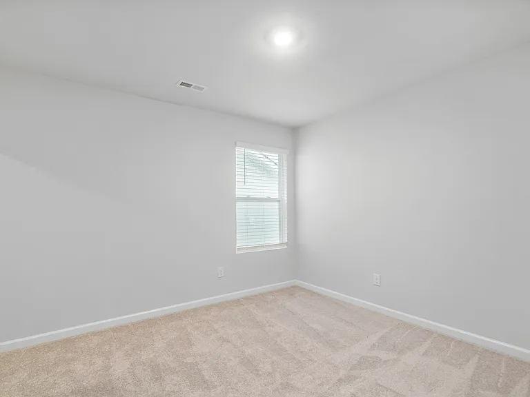 Upstairs bedroom 2 with ceiling fan.