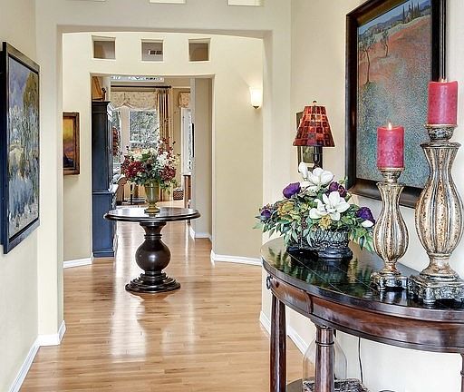 Dramatic rotunda foyer with sky lights and sconce lighting.