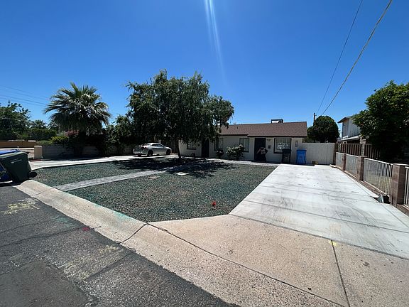 Wide angle view of home with two separate driveways, one for each apartment.