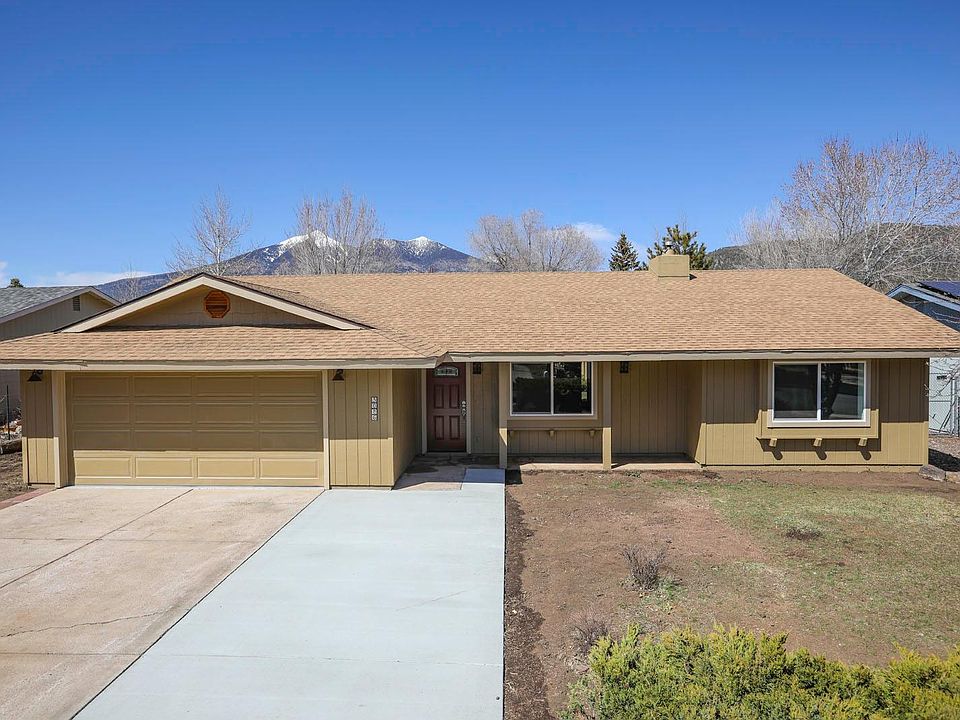 Exterior of 3086 Cooper. South facing driveway with three parking spots. New windows, new roof, new paint.