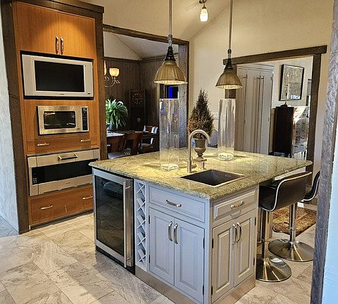 TV, Microwave, oven, dining room and island and entrance to the living area