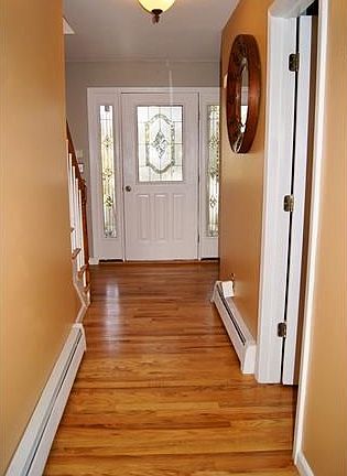 View of front door from kitchen.  Hardwood Floors as shown.