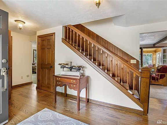 Classic colonial entry way with Birch Hard wood floors, solid core doors. 