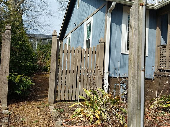Gravel walkway around end of house.