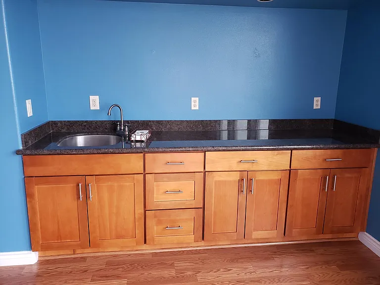 Upstairs sink/built in storage/buffet area.