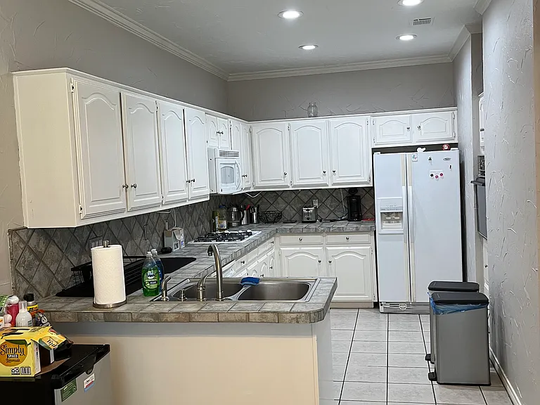 Large Kitchen with all appliances - oven, cooktop, refrigerator, microwave, & garbage disposal. Plenty of cabinet space. Shared space.