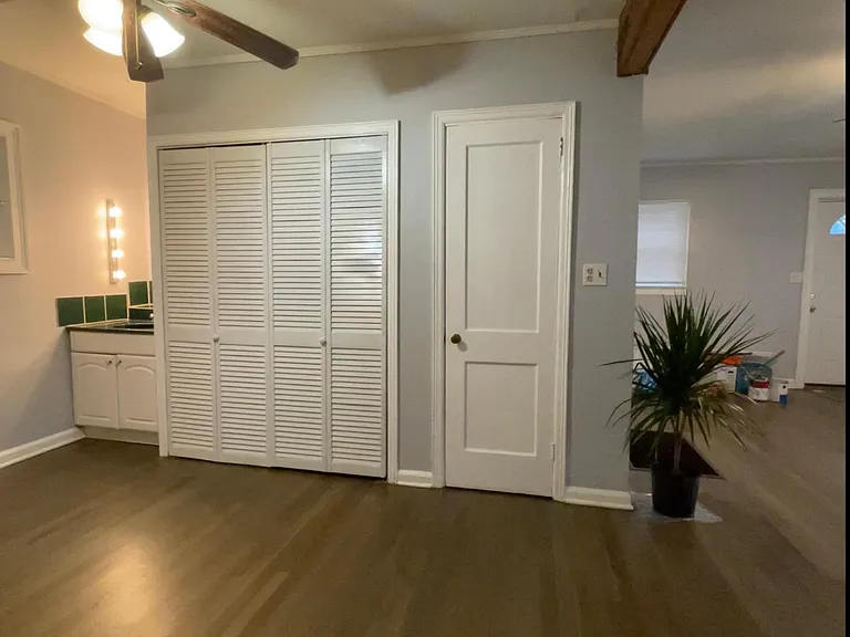 View of 1/4 Bath, (left)....enclosed full laundry (center) with new washer & dryer.....Bedroom Closet (right)
