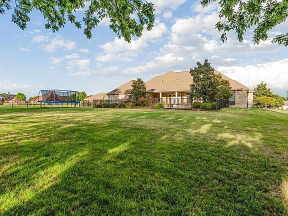 Oversized Backyard boasts a fenced pool.