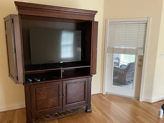 This is the armoire for the master bedroom suite. The TV is not included. You can see the door to the main screened porch just off of the master bedroom