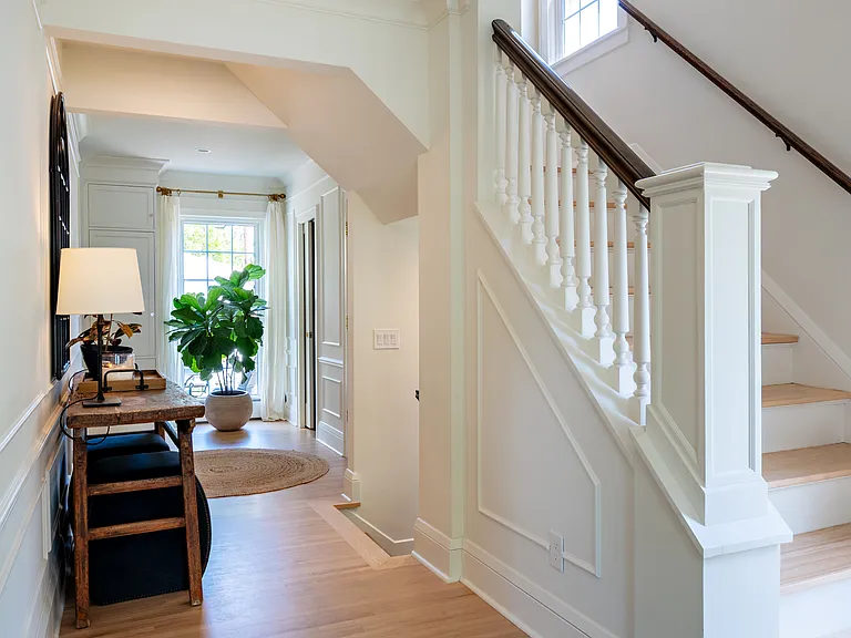Expansive entry opening up to back of the home. Includes access to up and down stairs and the powder room.