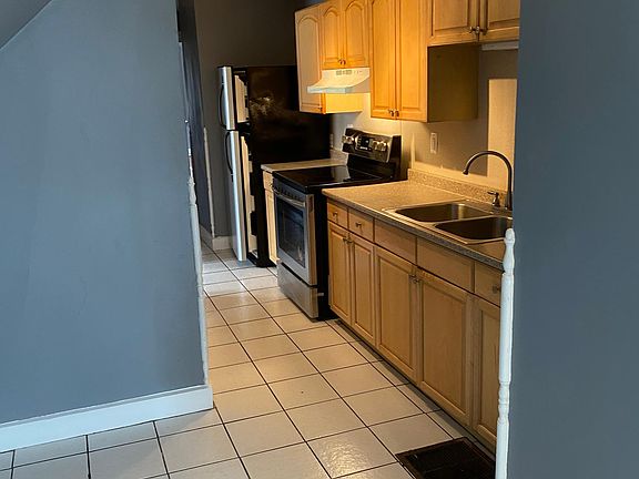 Kitchen, double sinks, new SS stove and SS refrigerator.