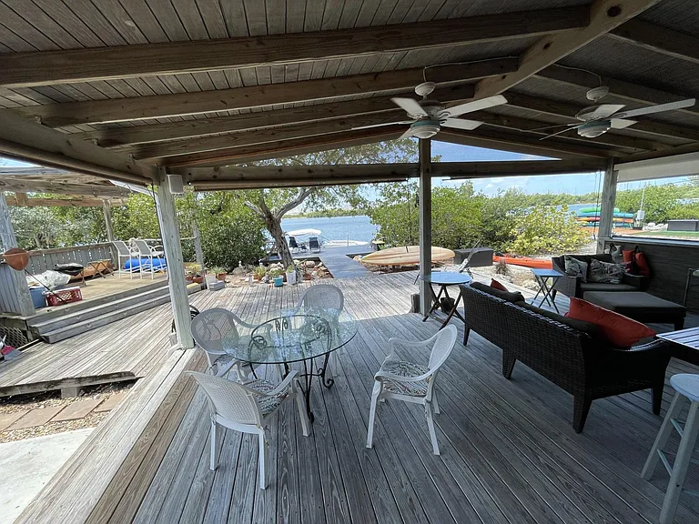 Covered outside dining area and lounge area as well as a gazebo.