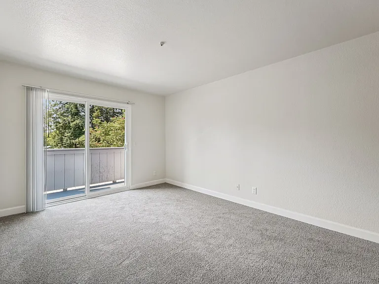 Spacious bedroom with private balcony.