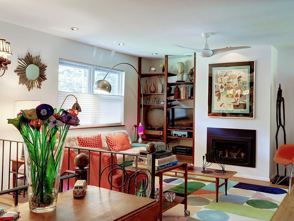 Marko Grove Open Plan Living Area with Gas Fireplace and Mid-Century Modern Furniture.