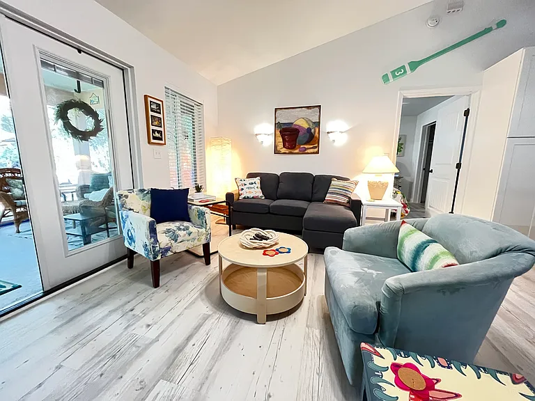 A large open living room allows a clear view of the lake through French Doors and windows with easy access to a front screened porch. Open Living concept allows for everyone to enjoy conversations including the cook.