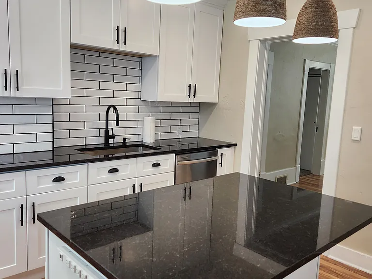 New cabinets, granite countertops, and tile backsplash