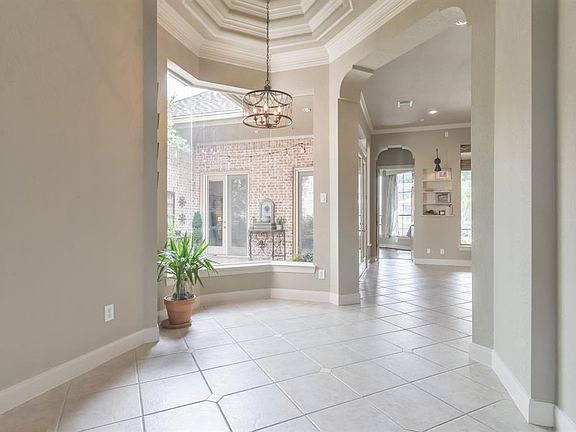 Grand entry with stepped rotunda and views of the private courtyard.