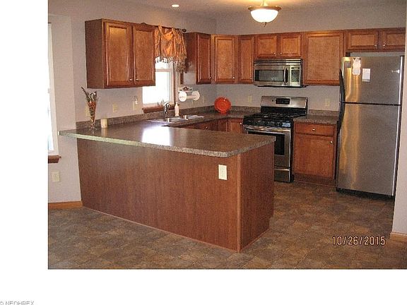 Attractive, spacious kitchen featuring breakfast bar and stainless steel appliances.