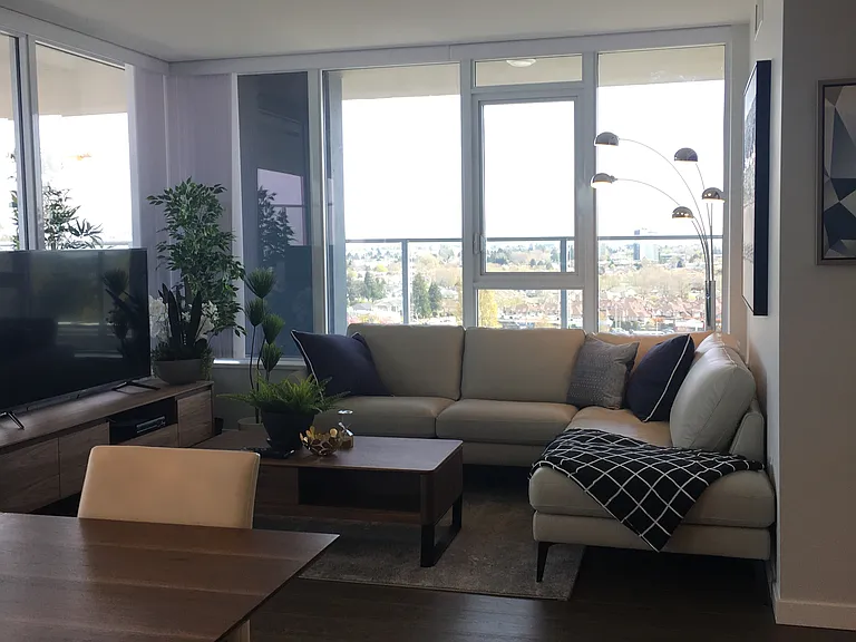 Living & dining room area surrounded by windows.