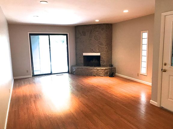 Spacious living room with fireplace, sliding patio door to s