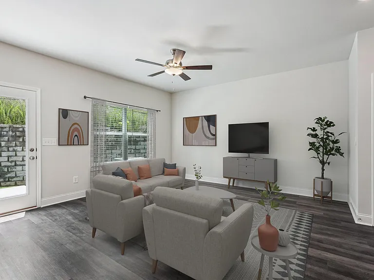 Bright living room featuring a large window that fills the space with natural light.