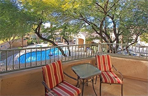 The view from the upstairs balcony is incredible! Enjoy landscaping with mature trees along with the