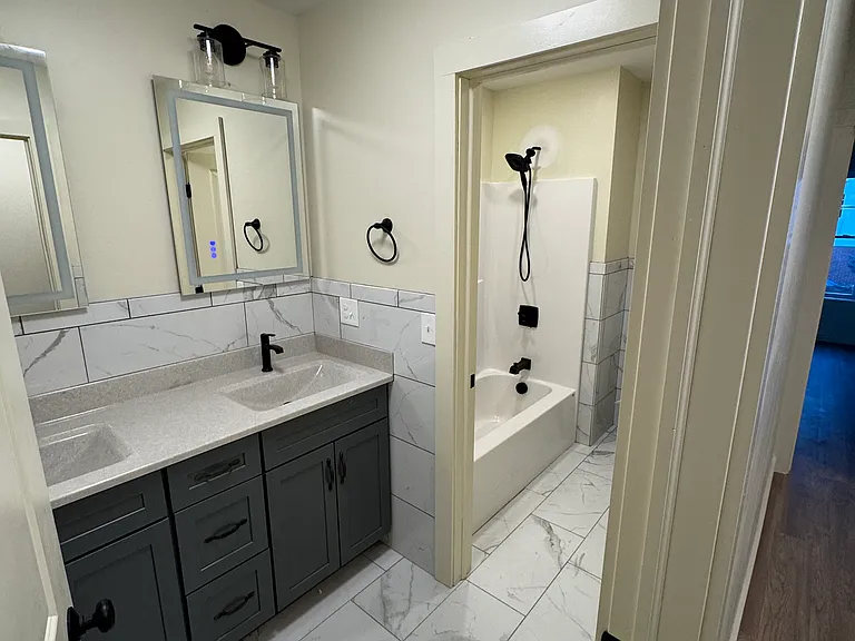 Full bathroom, lighted mirrors, plenty of storage, tiles
