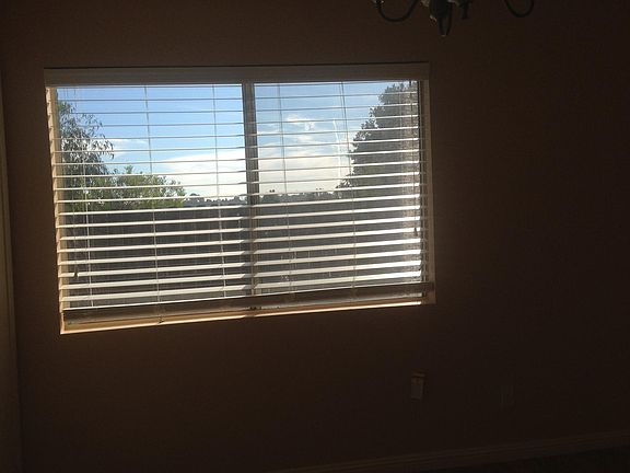 Extra bedroom with view of patio and ocean view in the distance.