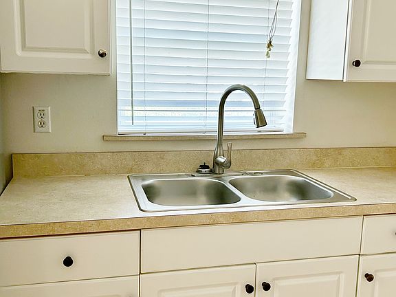Upgraded sink and faucet. Deep window sill for growing herbs.