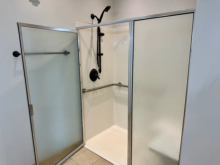 Primary bath with roll in shower and heated floors
