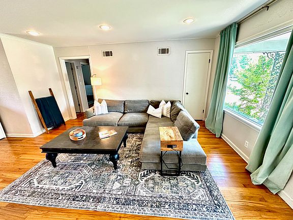 Living room has large front window looking out to the front porch as well as a coat closet.