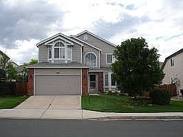 Front of house with beautiful landscaping.