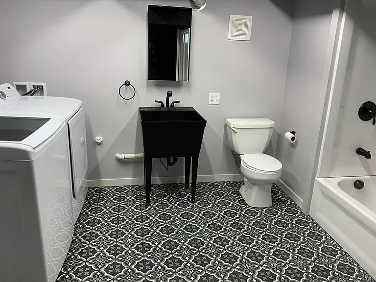 Lower level laundry shower and bath