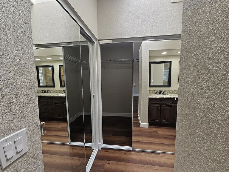 Master walk-in closet has full-length mirrors