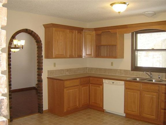 Large Kitchen with brickarch way into diningroom