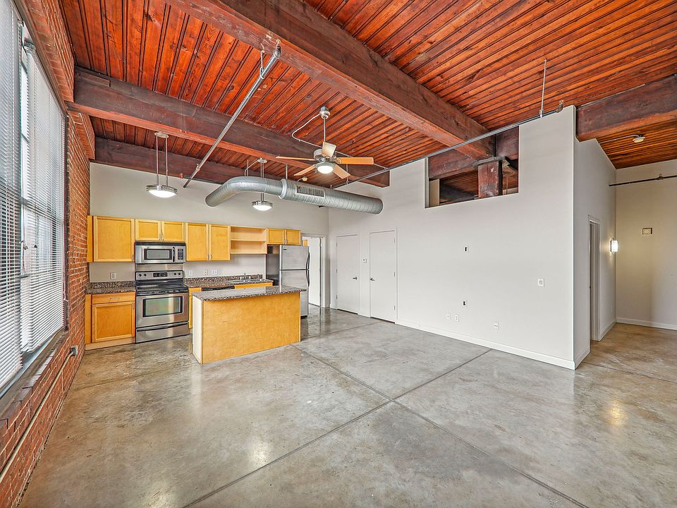 Open concept design, exposed beams, polished concrete flooring