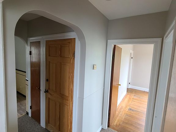 Hall way with bathroom to the right and kitchen area to the left. The closed door in the middle is the front door.