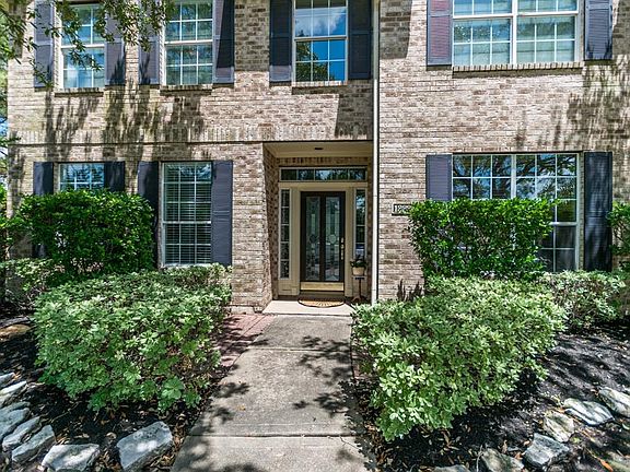 Manicured landscaping surround the front elevation.