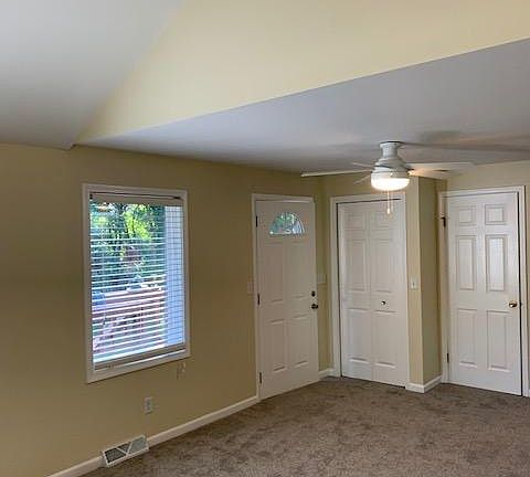 Front door, closet, and basement door. View from living room.