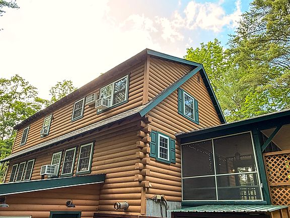 this picture shows the main floor and upper floor of rental. Lots of windows with view to the woods.