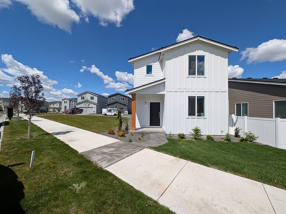 Front entrance located on premium corner lot. Grass area along street and to the left of house is maintained by HOA.
