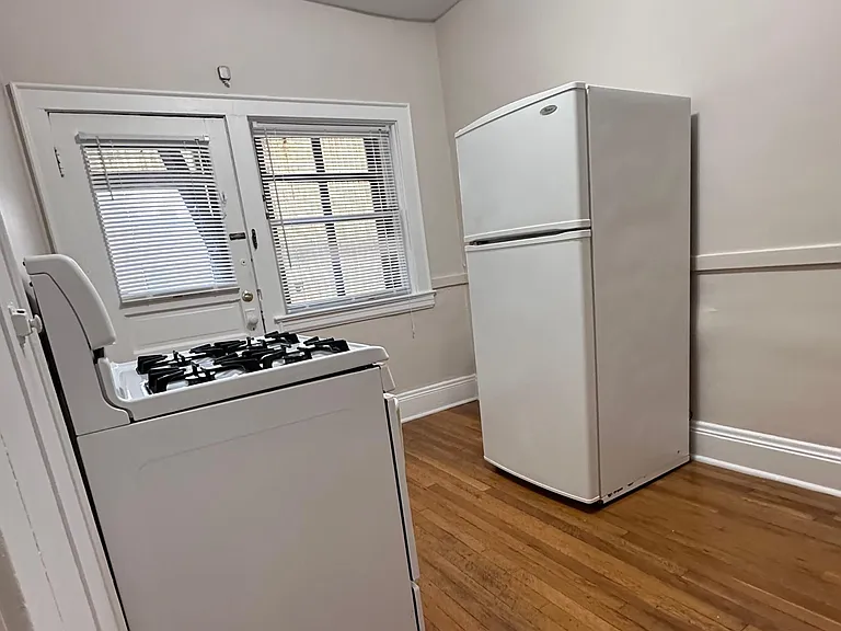 Kitchen with separate back entry leading to laundry rooms and parking