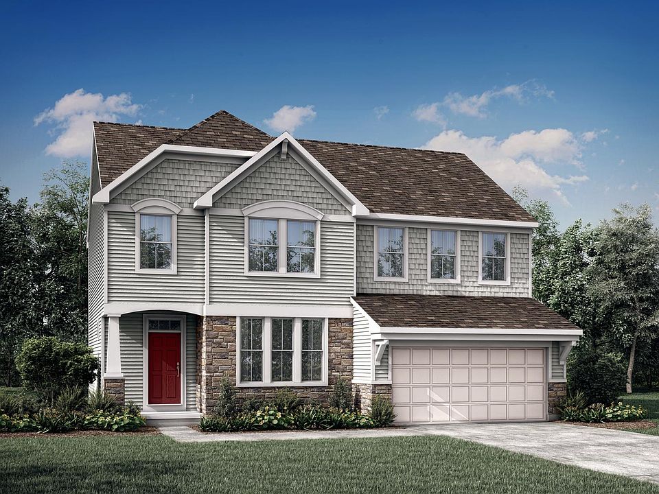 custom two-story home with stone, siding and shakes