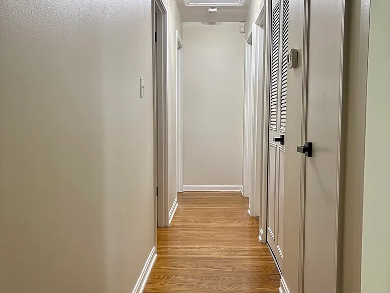 Hallway with coat closet and pantry