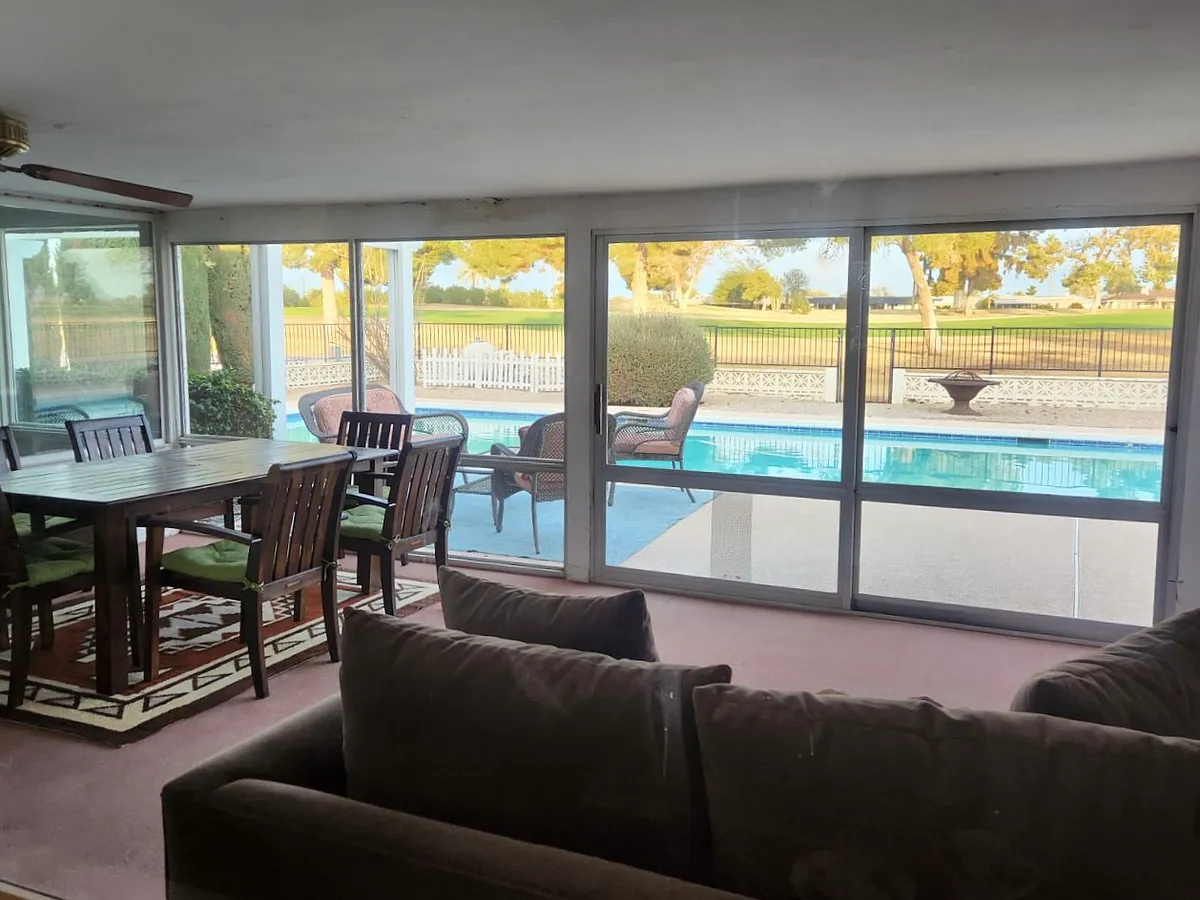 Screened patio with dining and sitting areas - 15806 N Nicklaus Ln